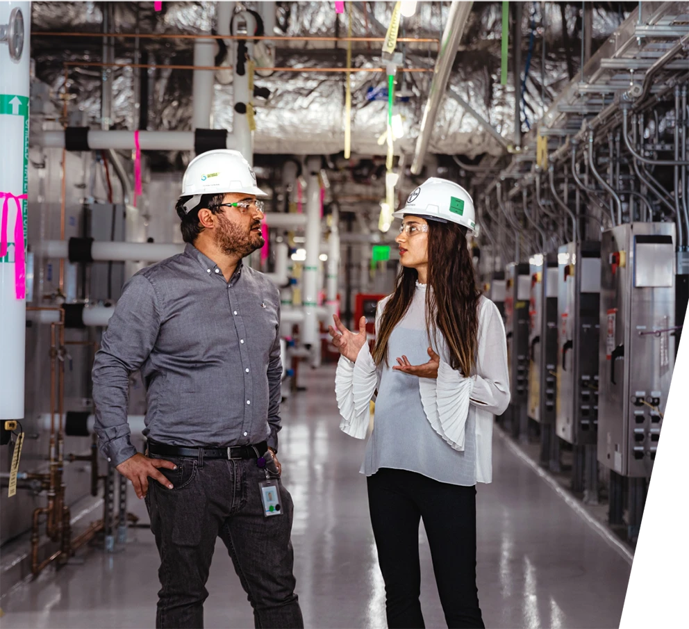 Casqued workers having a discussion in an electric&nbsp;room