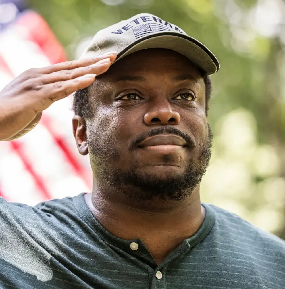 Veterans saluting in front of the&nbsp;flag